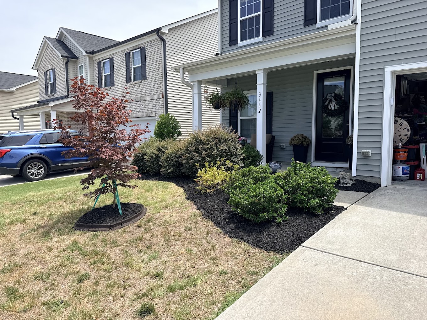 Pressure washing a concrete driveway showing clean line