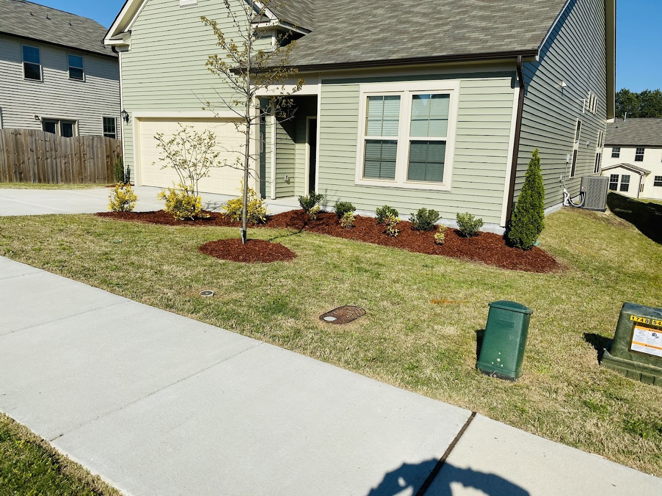 Professionally landscaped front yard with mulched beds and flowers